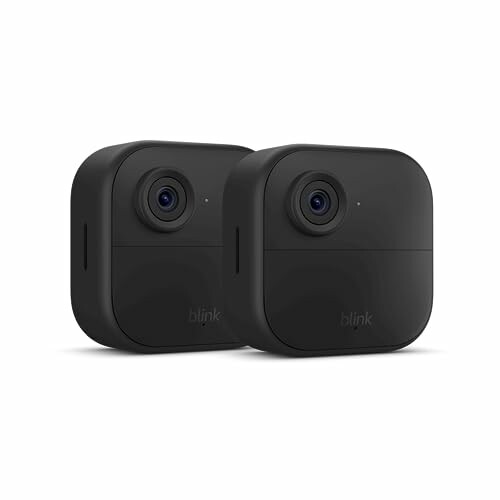 Two black Blink outdoor security cameras.